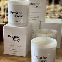 Load image into Gallery viewer, eucalyptus blend candle in a 300-gram white glass vessel, featuring 1 cotton wick. Infused with essential oils of eucalyptus, peppermint, menthol, and a hint of lavender. Boxed and perfect for easing blocked noses in winter.”
