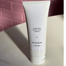 Load image into Gallery viewer, A 100ml bottle of lightweight hydrating hand and nail cream infused with a sensual fragrance inspired by Baccarat Rouge. Contains purified water, avocado oil, jojoba oil, macadamia oil, shea butter, cocoa butter, and aloe vera leaf juice powder. Suitable for daily use.