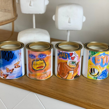 Load image into Gallery viewer, A 420-gram cocosoy candle in a paint tin with artwork by Lachlan Muller, featuring a gloss laminate finish and up to 80 hours of burn time. Perfect for upcycling into a pen holder or makeup brush holder.