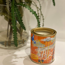 Load image into Gallery viewer, A 420-gram cocosoy candle in a paint tin with artwork by Lachlan Muller, featuring a gloss laminate finish and up to 80 hours of burn time. Perfect for upcycling into a pen holder or makeup brush holder.
