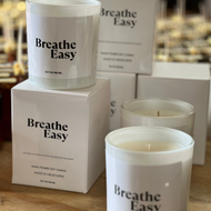 eucalyptus blend candle in a 300-gram white glass vessel, featuring 1 cotton wick. Infused with essential oils of eucalyptus, peppermint, menthol, and a hint of lavender. Boxed and perfect for easing blocked noses in winter.”